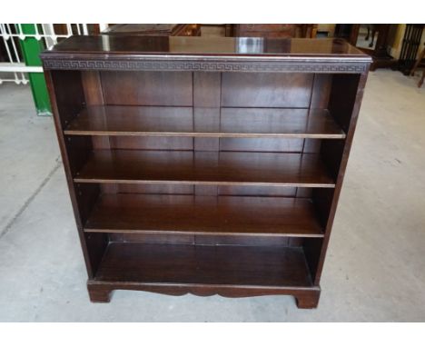 A mahogany Open Bookcase with key pattern carved decoration on bracket feet.  3' (92cms) wide. 