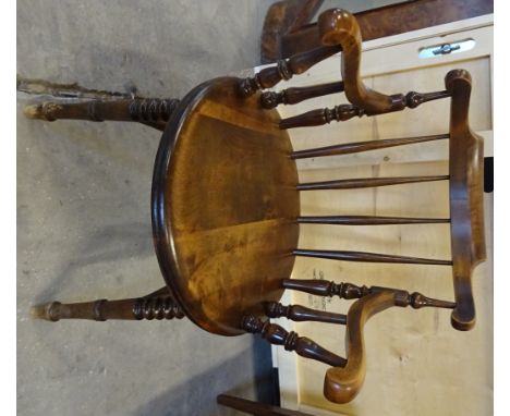 A beech frame Elbow Chair with stick back circular panel seat and scroll arms on ring turned supports. 