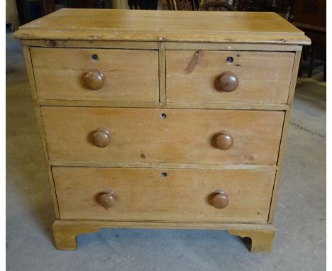 A small pine Chest with moulded edge, two long and two short drawers with turned pull handles on bracket feet.  2' 5" (74cms)