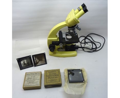 An electric Binocular Microscope by Cooke Troughton & Simms Ltd., York and a number of boxes of magic lantern slides.