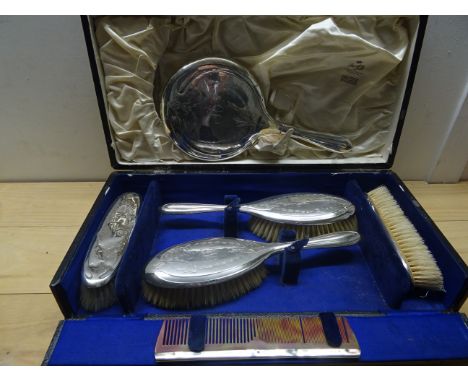 A silver six piece Dressing Table Set engraved with trailing harebells, Birmingham, 1925, together with a comb of a different