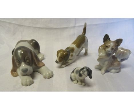 A Lladro figure of a sleeping Puppy, boxed, a miniature Lladro figure of a puppy, boxed and two other Lladro dog ornaments.