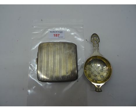 An engine turned silver Cigarette Case, Birmingham, 1923 and a silver tea strainer.  (5.1ozs)