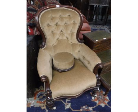 A VICTORIAN WALNUT FRAMED BUTTON BACK ARMCHAIR with matching foot stool upholstered in gold velvet