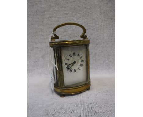 A FRENCH BRASS-CASED CARRIAGE CLOCK of oval shape with bevelled glass panels, 5" high