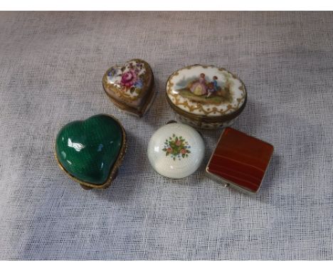 A WHITE METAL AND ENAMEL PILL BOX with floral decoration and four other similar patch or pill boxes (5)