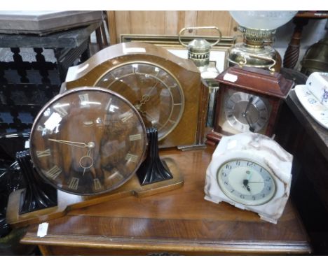 A 1950S WALNUT MANTEL CLOCK on Bakelite supports and three similar clocks (4)