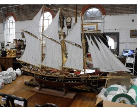 A SCRATCH BUILT OR MODEL SAILING SHIP with rigging and a detailed deck, 64" long