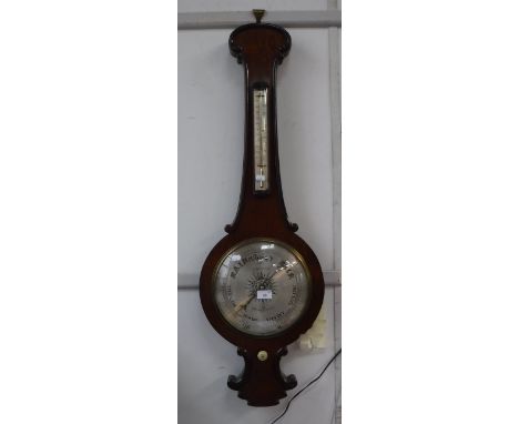 A REGENCY ROSEWOOD WHEEL BAROMETER, the circular silvered dial signed "Logan Dorchester", 41" high