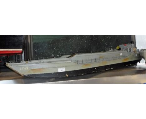 A SCRATCH BUILT OR KIT MODEL OF A MILITARY VEHICLE CARRIER with a collection of military vehicles and a detailed deck, 48" lo