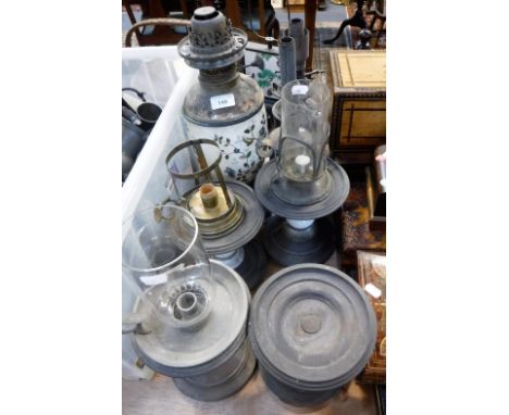A VICTORIAN SPELTER OIL LAMP with a ceramic body, a collection of brass oil lamps and similar items