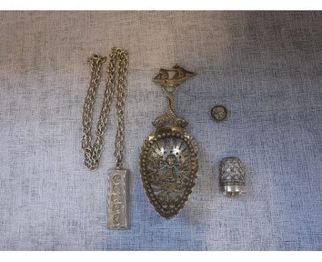 A SILVER INGOT attached to an unmarked white metal chain and a collection of similar items