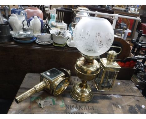 A BRASS CARRIAGE LAMP, a table oil lamp and a hand held brass oil lamp (3)