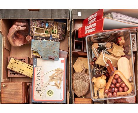 A collection of wooden puzzles, carvings and a model, late 20th/21st century&nbsp; and a Victorian brass mounted cribbage boa