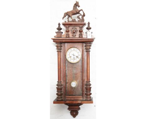 A walnut Vienna wall clock, c1900, with painted composition prancing horse cresting, gridiron pendulum, 89cm h  Requires rest
