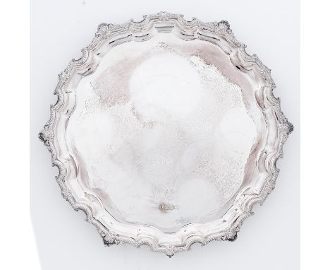 An Elizabeth II silver salver with Paul de Lamerie style border, on three volute feet, 27.5cm diam, by Francis Howard Limited