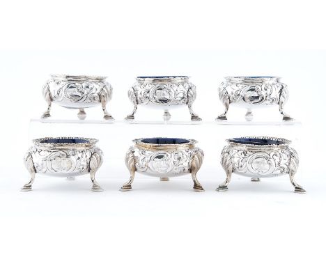 A set of six Scottish Victorian silver salt cellars, chased with rocaille, on hoof feet, Carmichael crest, traces of gilding,