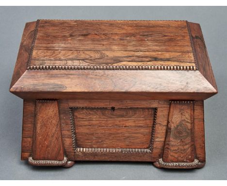 A William IV rosewood tea chest, of sarcophagus shape with pilasters, the fitted interior retaining part of one caddy, bun fe