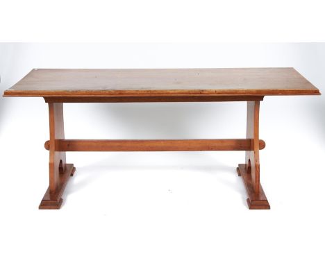 A light oak table, mid 20th c, the boarded top with moulded lip on profile trestles united by pegged stretcher, 73cm h; 75 x 