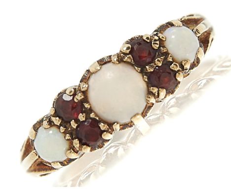 An opal and garnet ring, in 9ct gold, London 1971, 3.4g, size Q  Polish on opals scratched