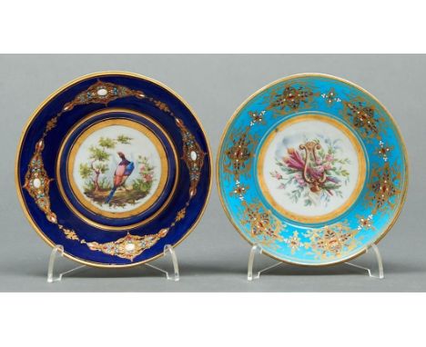 Two French jewelled porcelain cabinet saucers, late 19th c, in Sevres style, painted with a bird or musical trophy in blue or