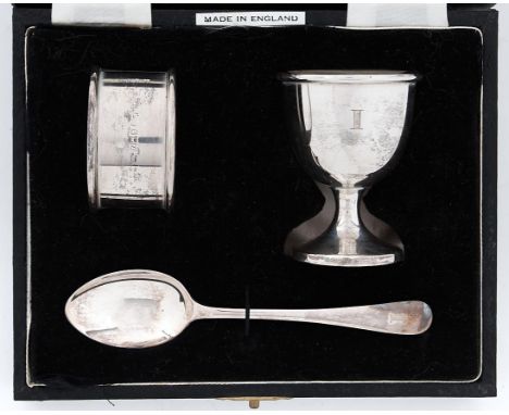 An Elizabeth II silver christening set of egg cup, spoon and napkin ring, initialled I, by William Adams Ltd, Birmingham 1960