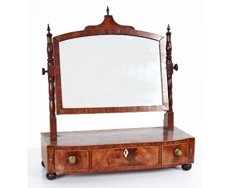 A George IV mahogany dressing mirror with turned uprights, the bow centred base crossbanded in rosewood and line inlaid fitte