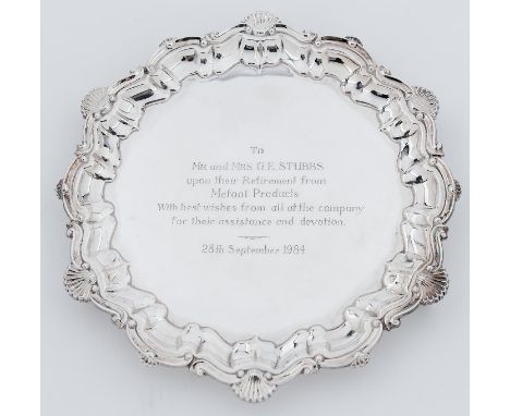 An Elizabeth II silver salver on three volute feet, 26.5cm diam, by Frank Hawker Limited, Birmingham 1972, 20ozs 7dwts  Light