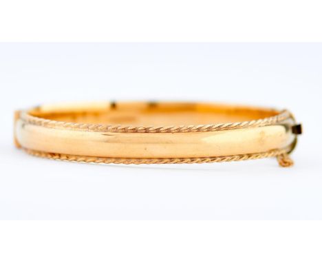 A 9ct gold bangle, 67mm, Birmingham 1991, 17g  Slightly scratched consistent with normal wear