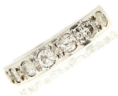 A seven stone diamond ring, the brilliant cut diamonds flush set in 18ct white gold, 6.2g, size O  