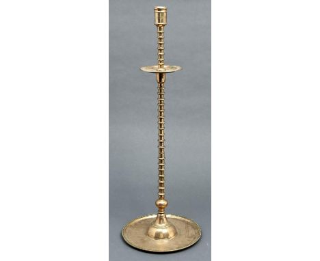 An Islamic brass candlestick, 18th / 19th c,&nbsp;the moulded sconce on multi-knopped pillar and drip pan, dished foot, 81cm 