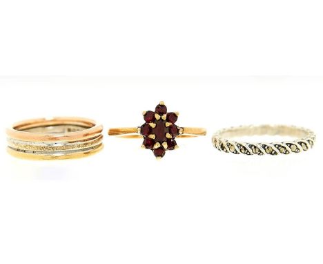 A three colour&nbsp;9ct gold ring, Sheffield 1994, 4.7g, a garnet cluster ring in 9ct gold and a marcasite eternity ring, siz