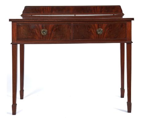 An Edwardian mahogany two drawer side table, c1910, the shaped upstand above a rectangular top with reeded lip above two figu