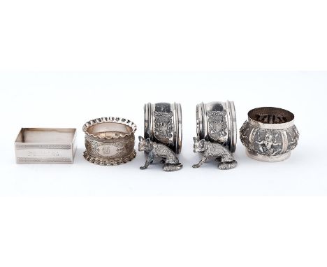 A pair of Edwardian EPNS seated fox napkin rings, another, a rectangular silver napkin ring and an Indian silver repousse exa