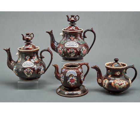 Three Bargeware teapots and covers, one other and a teapot stand, late 19th c, typically sprigged and painted with flowers on