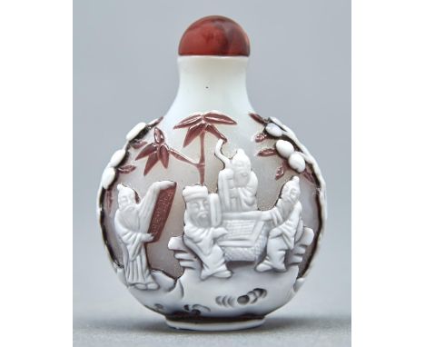 A Chinese triple overlay cameo glass snuff bottle, 20th c, in opal glass overlaid in mushroom brown and white, carved to eith