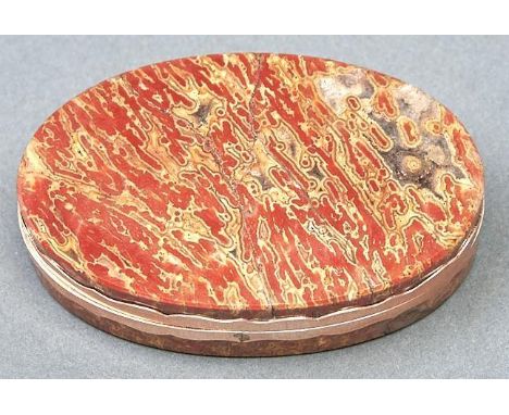 An oval giltmetal mounted hardstone snuff box, early 19th c,&nbsp;with wavy edged mount, 76mm l  Lid broken in four pieces an