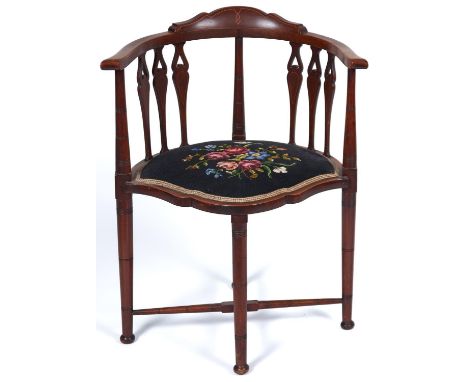 An Edwardian mahogany tub chair, c1905, the flat top rail with shaped boxwood inlaid cresting above ring turned pillars and t