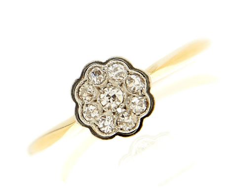 A diamond cluster ring in gold marked 18ct, 2.8g, size R½  Light wear