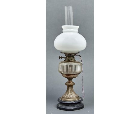 A Victorian brass oil lamp, c1900, the trumpet foot embossed with ears of wheat alternating with stiff leaves beneath flute c