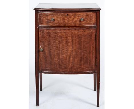 A bow fronted mahogany cupboard, early 20th c, with fiddle back veneered drawer and door, on square tapered legs, 78cm h; 44 
