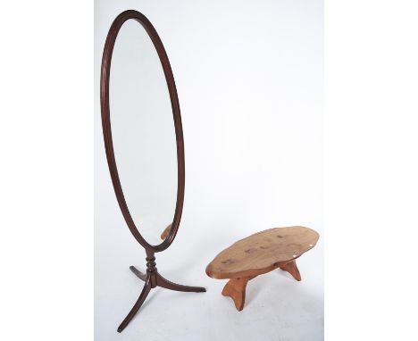 An adjustable oval mahogany cheval mirror on tripod, late 20th c, 163cm h and an oak coffee table (2)  Good condition