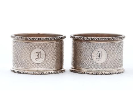 A pair of George VI silver napkin rings, engine turned, by Crisford &amp; Norris limited, Birmingham 1937, 3ozs 5dwts  Good c