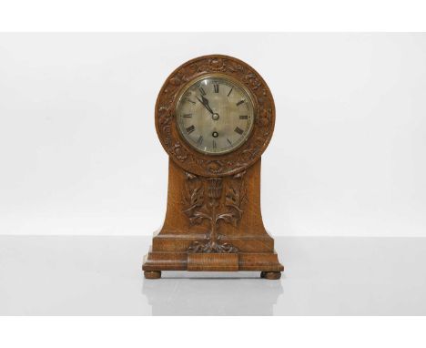 A Scottish Arts and Crafts oak mantel clock, by John Crawford &amp; Co., Glasgow, profusely carved with grapes and acorns to 