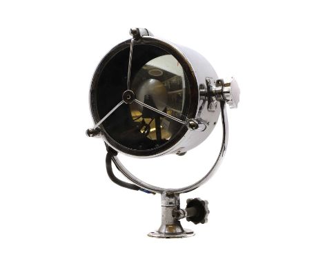 A chrome Francis Searchlight,  with a cage, a concave mirror back, an adjusting dial, the light on a rack and a pinion mount,