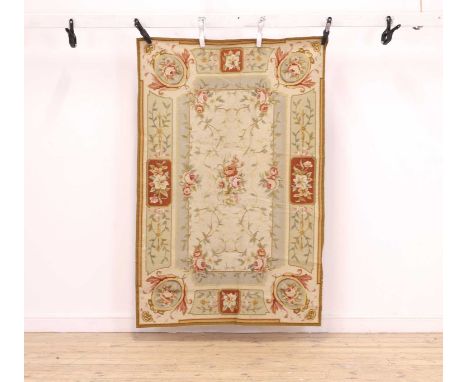 A needlepoint rug  20th century, of needlepoint design, woven with flowers and scrolling foliate motifs,177 x 116cmCondition 