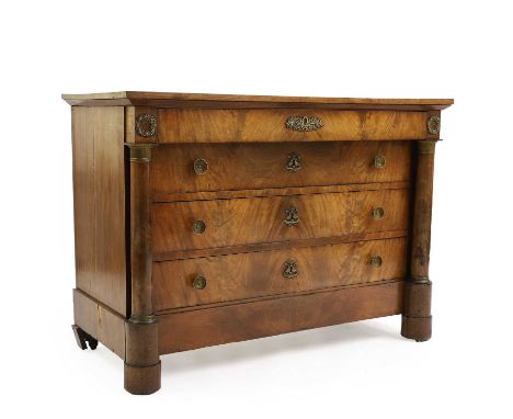 A flame mahogany commode,  19th century, Continental, with four long drawers flanked by columns, on a plinth base and squat-t