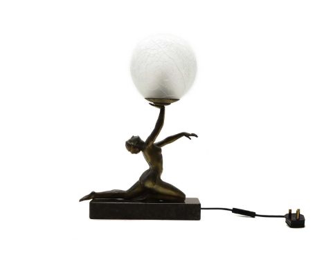 An Art Deco style spelter lamp, in the form of a nude figure supporting a crackled globular shade, raised on a marble plinth,