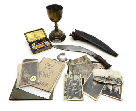 A collection of WWI & WWII medals and ephemera  comprising WWII Kukri knife, with an etched design, a flat pommel, and a carv