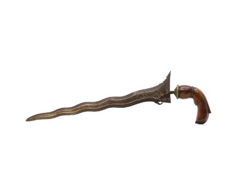 An Indonesian Kris  19th century, the blade of typical form with a Damascus type finish, with a carved walnut grip, blade 35c